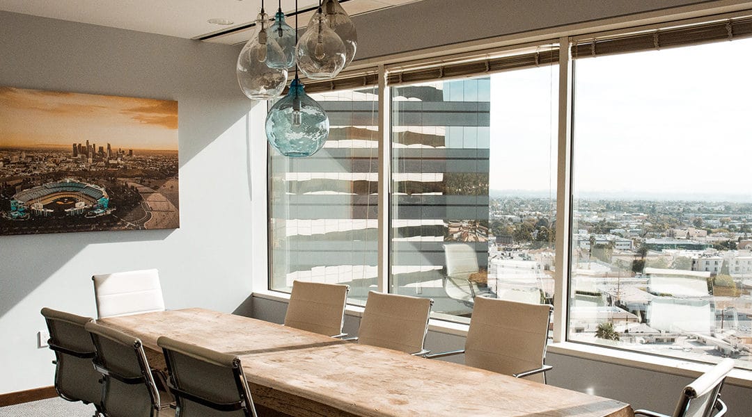 Urban office overlooks city lined with palm trees