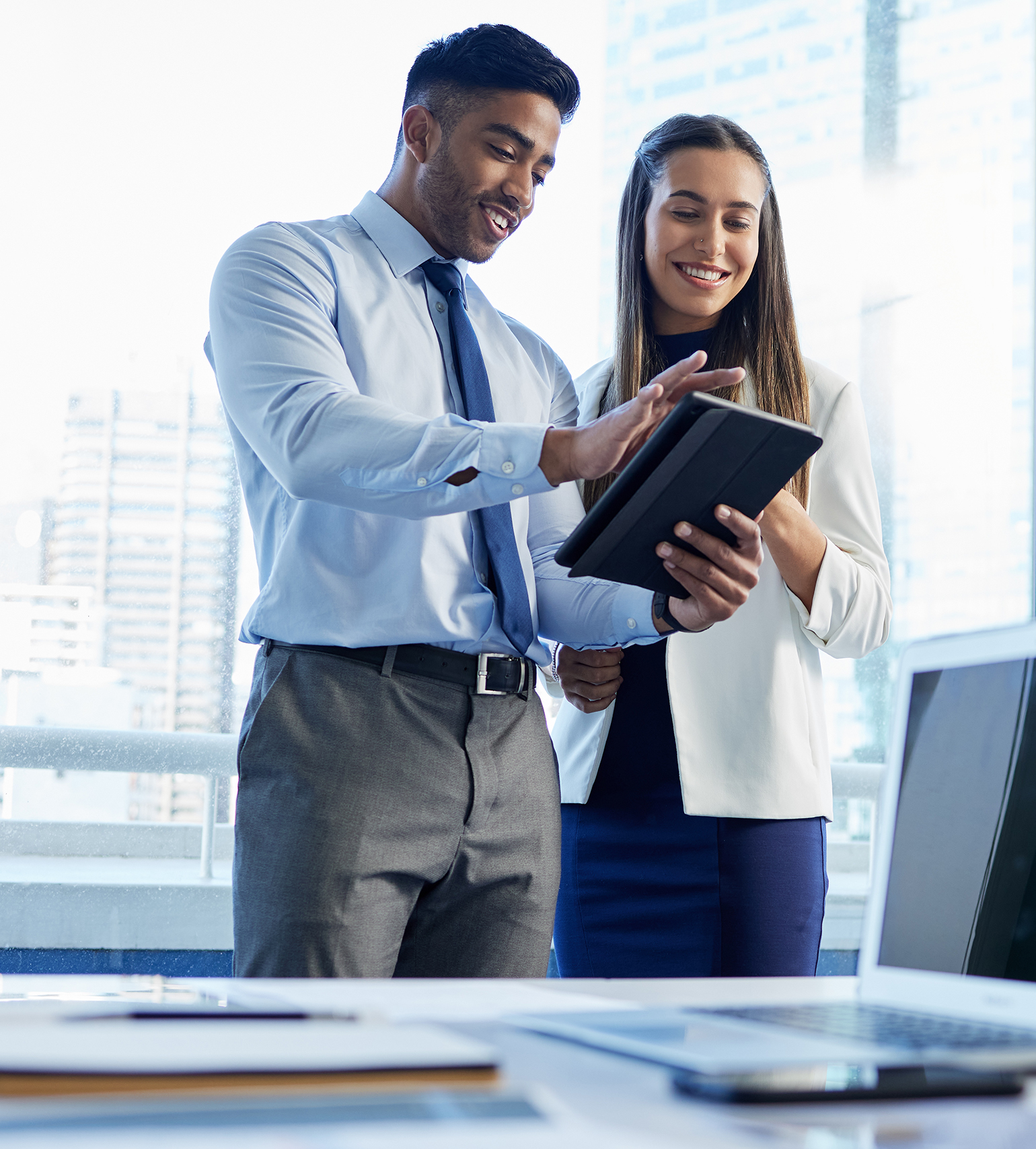 Shot of two businesspeople discussing something on a digital tablet